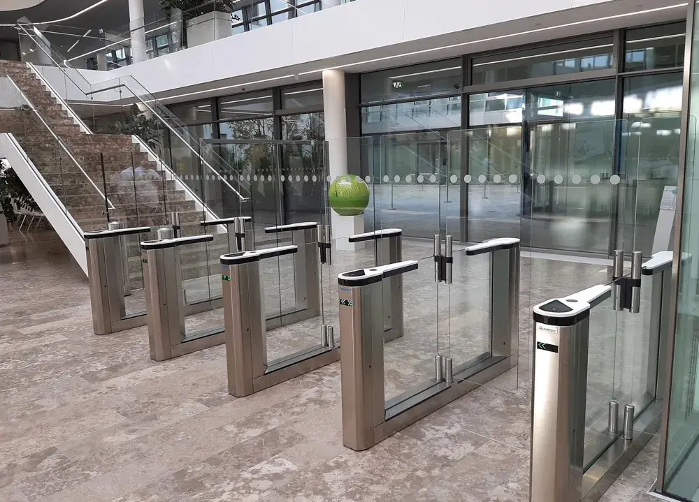 Speed gate entrance-control lanes installed inside a modern commercial lobby.
